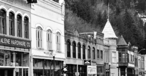 Black and white photo of historic downtown Wallace, Idaho featuring vintage buildings.