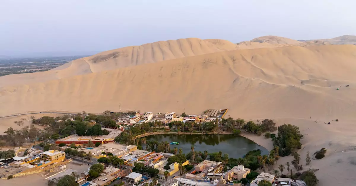 A breathtaking aerial view of the Huacachina oasis surrounded by sand dunes in Ica, Peru.