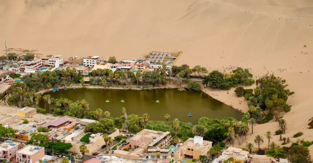 Huacachina Peru Travel Guide: Desert Oasis Adventure 1 Stunning aerial shot of Huacachina oasis surrounded by desert dunes in Ica, Peru.