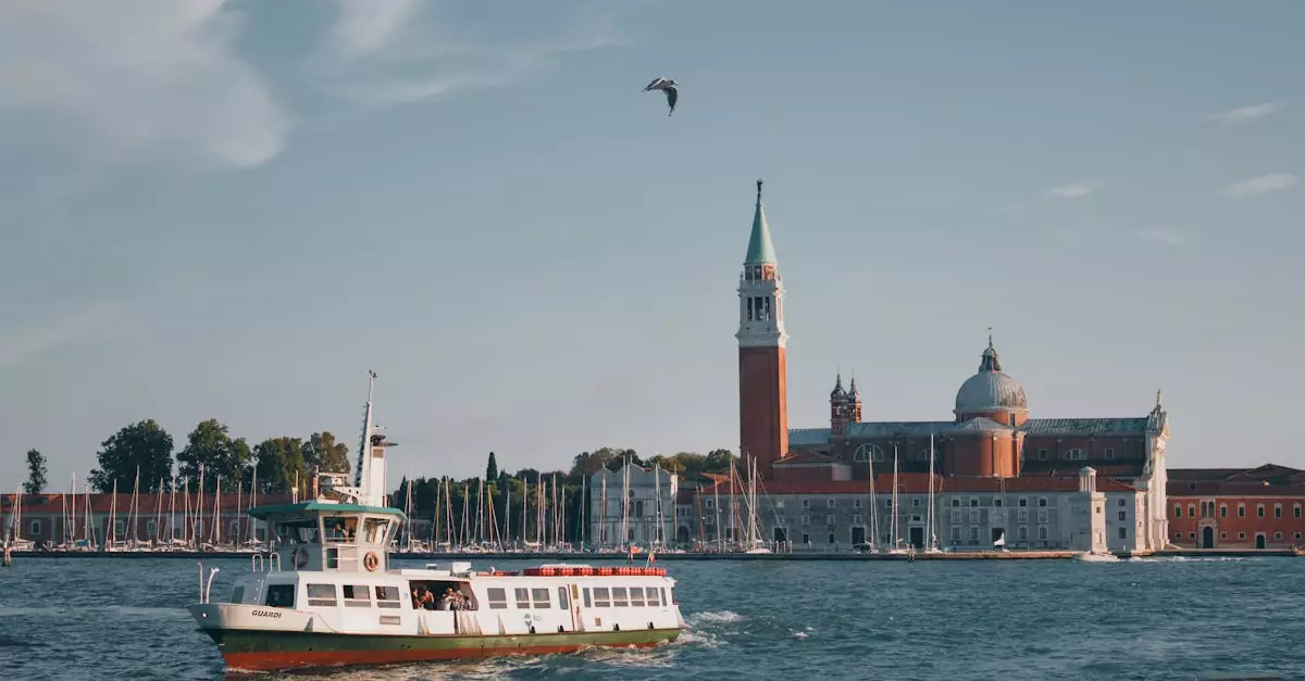 Scenic view of San Giorgio Maggiore with boats on the Grand Canal in Venice, Italy, under a clear summer sky.