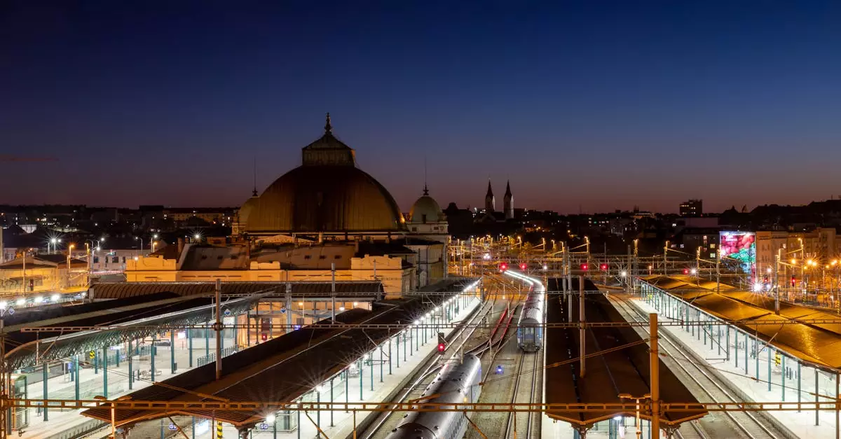 Stunning night view of Plzeň Main Railway Station, showcasing urban architecture and vibrant city lights.