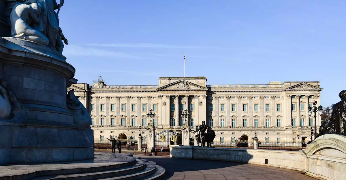 Stunning view of Buckingham Palace with clear blue skies and iconic statues in London, England.