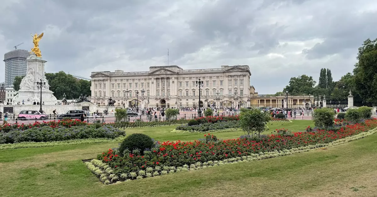 Iconic view of Buckingham Palace and Victoria Memorial in London, with lush gardens and cloudy skies.