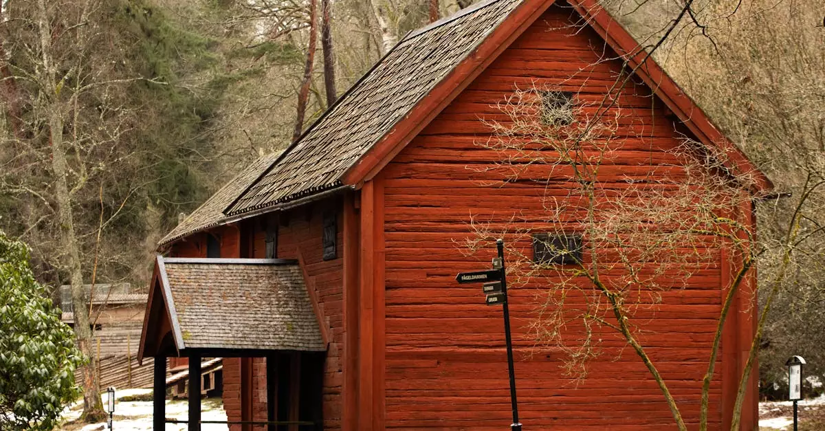 Red wooden house in J&ouml;nk&ouml;ping, Sweden, surrounded by winter trees.