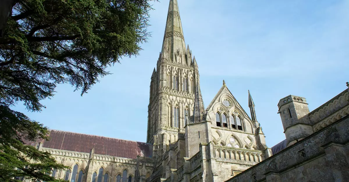 Salisbury Cathedral's stunning Gothic facade with a blue sky backdrop in England.