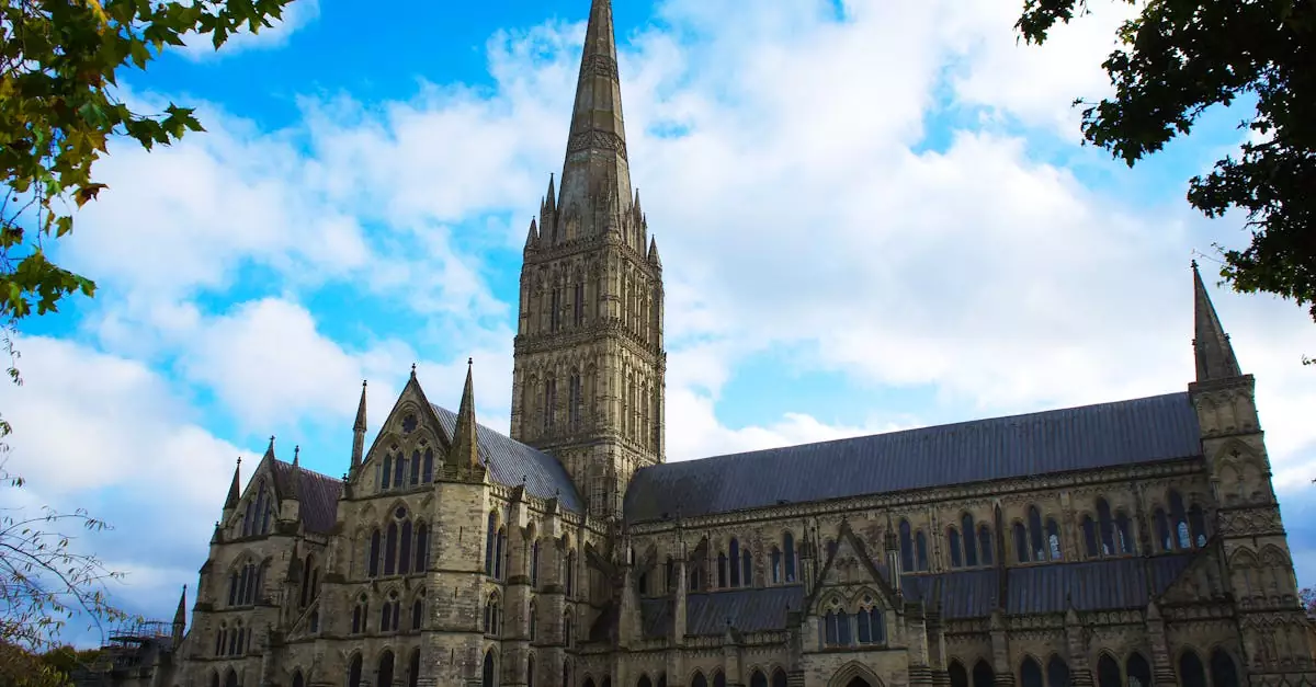 A breathtaking view of Salisbury Cathedral, showcasing its gothic architecture under a bright summer sky.