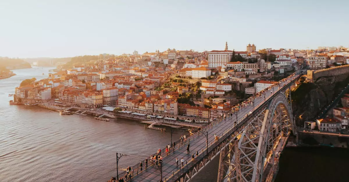 A stunning aerial view of Porto's historic cityscape and Dom Lu&iacute;s I Bridge over the Douro River at sunset.