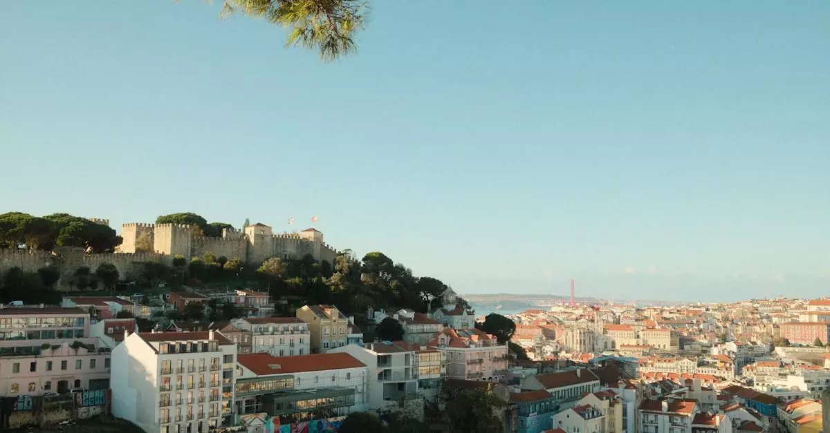 Explore the stunning cityscape of Lisbon featuring the iconic S&atilde;o Jorge Castle during a clear day.