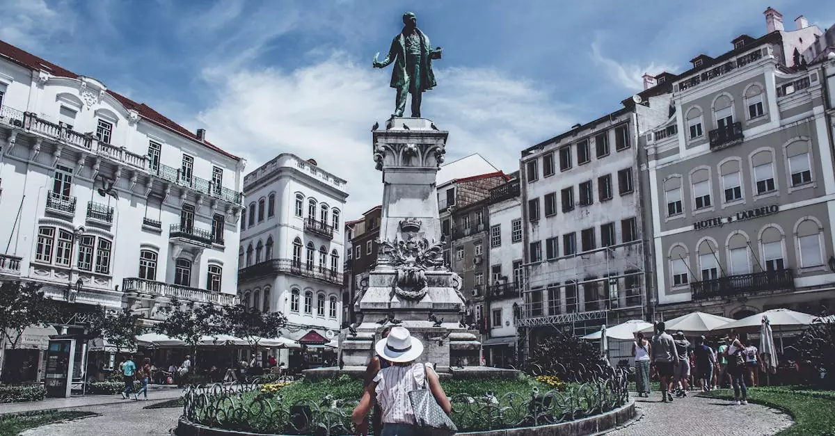 Monumental statue in a bustling Porto square, capturing local life and architecture.