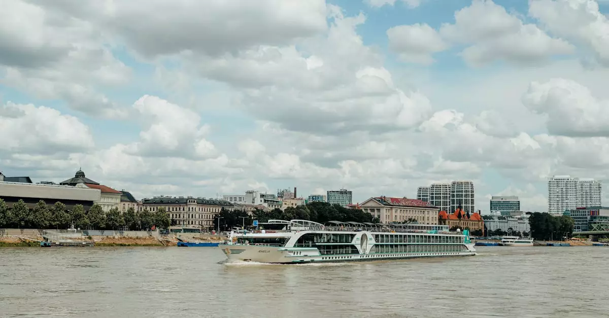 Scenic view of a cruise ship sailing the Danube River against the Bratislava skyline under a cloudy sky.