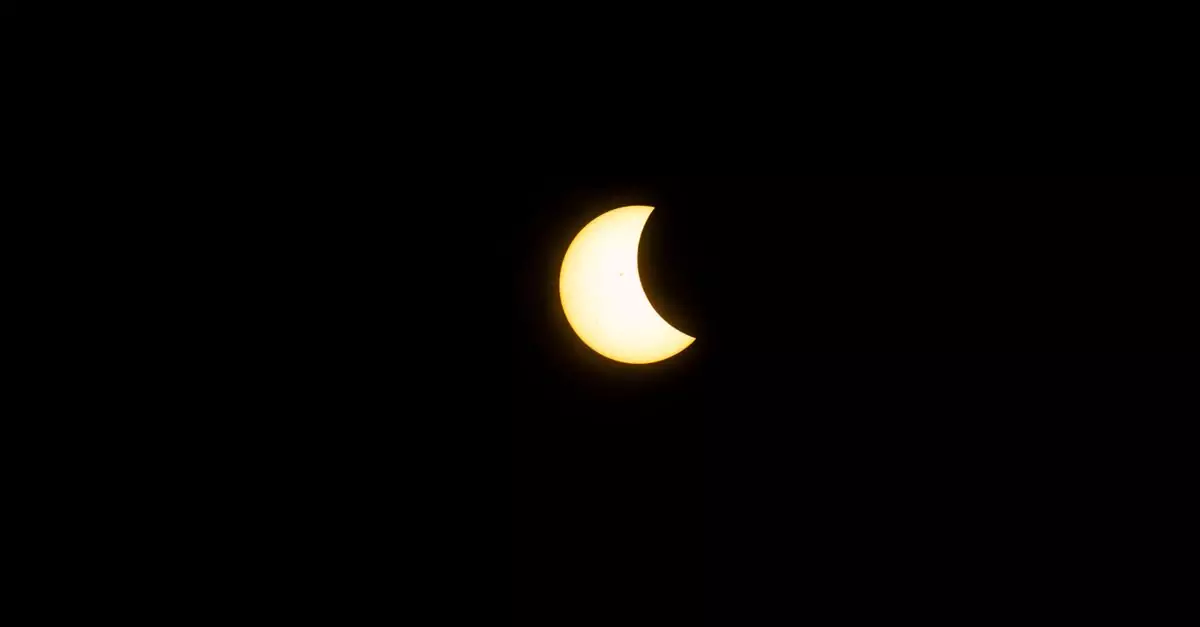 Captivating view of a partial solar eclipse captured in Mazatlán, Mexico, with a clear crescent shape.