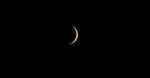Captivating solar eclipse crescent captured in Mazatlán, México, against a dark sky.