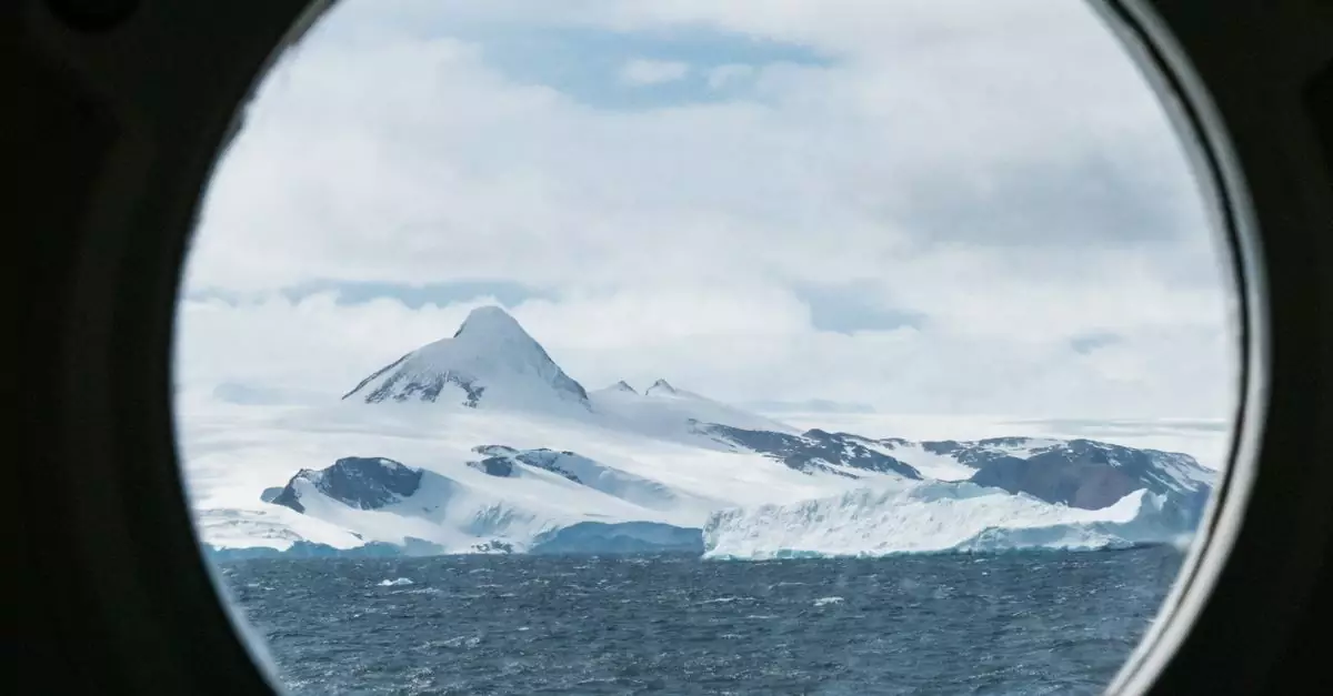 A stunning view of Antarctica's icy landscape through a ship's porthole, featuring snow-capped mountains and the open sea.