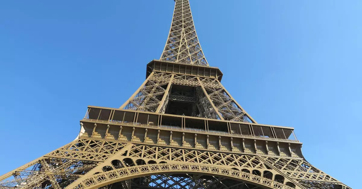Close-up of the Eiffel Tower against a clear blue sky in Paris, France.