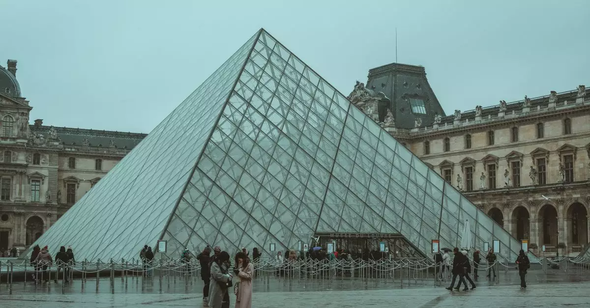 A winter day at the iconic Louvre Museum pyramid in Paris, capturing tourists and the architectural beauty.