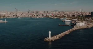 Scenic aerial view of Istanbul's coastline featuring a prominent lighthouse and bustling city skyline.