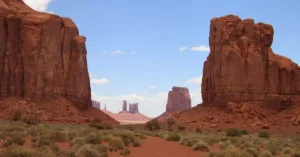 Beautiful landscape of Monument Valley with iconic red rock formations under a clear blue sky.