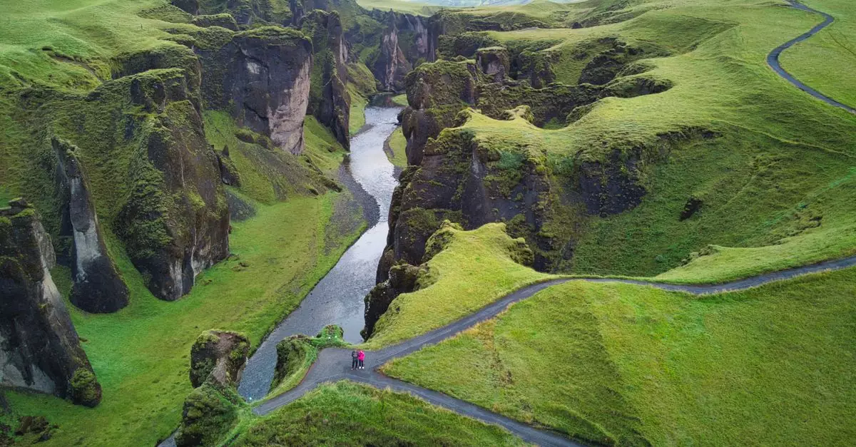 A breathtaking aerial view of the lush green Fjaðrárgljúfur Canyon in Iceland.