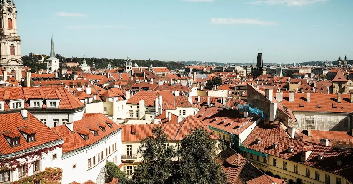 Explore the charming red-tiled rooftops of Prague's historic district under a clear blue sky.