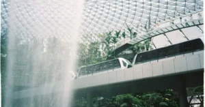 Scenic view of monorail passing behind the waterfall at Jewel Changi Airport, Singapore.