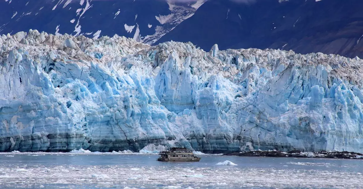 A breathtaking view of Hubbard Glacier with a boat navigating the icy waters in Alaska.