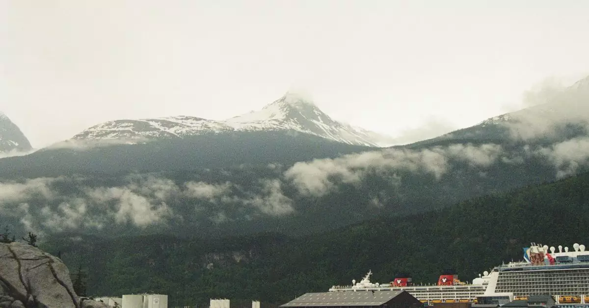 A cruise ship docked in a picturesque harbor with snow-capped mountains in the background, Skagway, Alaska.