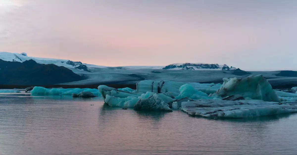 Serene view of Iceland's glacial lagoon with floating icebergs during sunset.