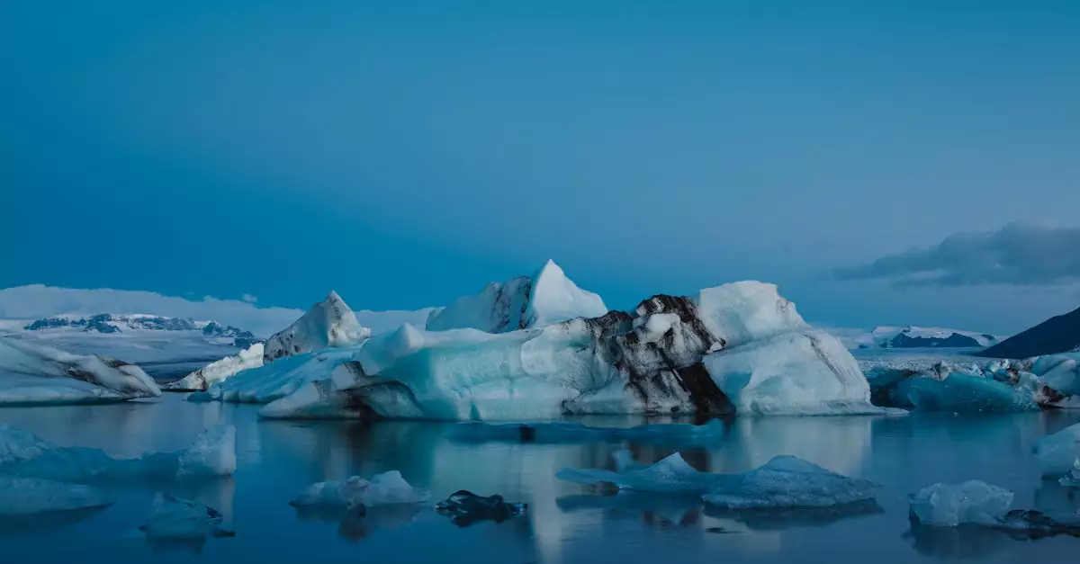 Stunning landscape of icebergs floating in serene waters under a clear sky in Iceland.