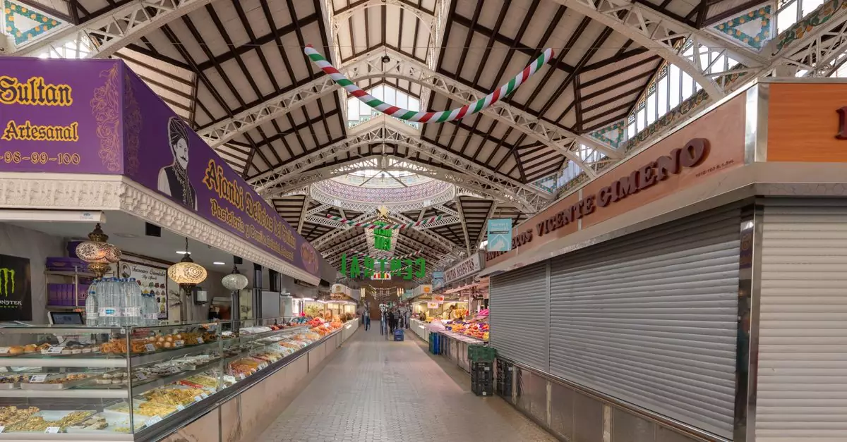 Interior view of Valencia's Central Market showcasing its architectural design and food stalls.