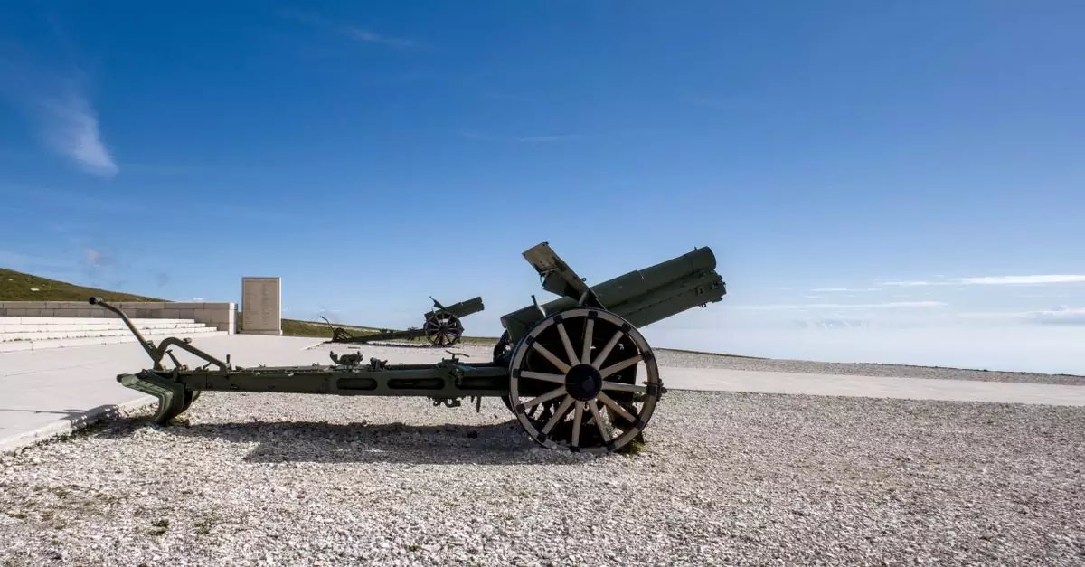Old artillery cannon on display under clear skies in Veneto, Italy, historic war artifact.