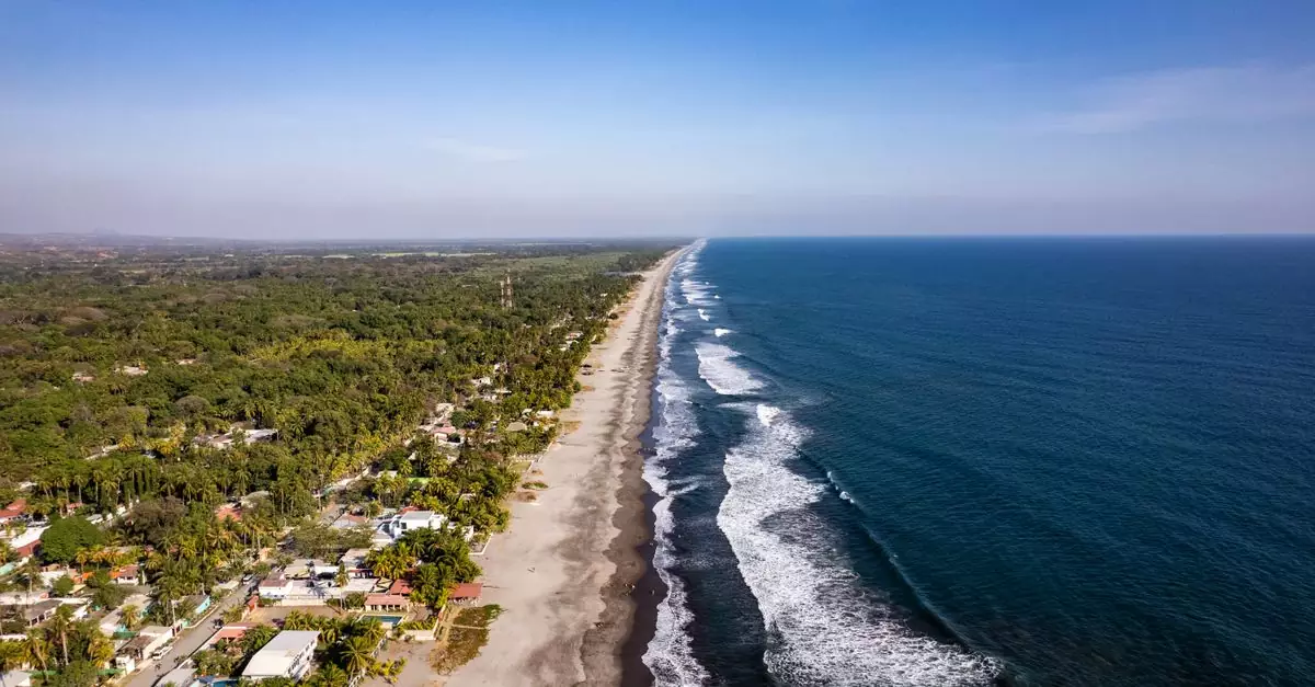 Stunning aerial view of La Libertad's coastline in El Salvador, capturing the vibrant beach and surrounding landscape.