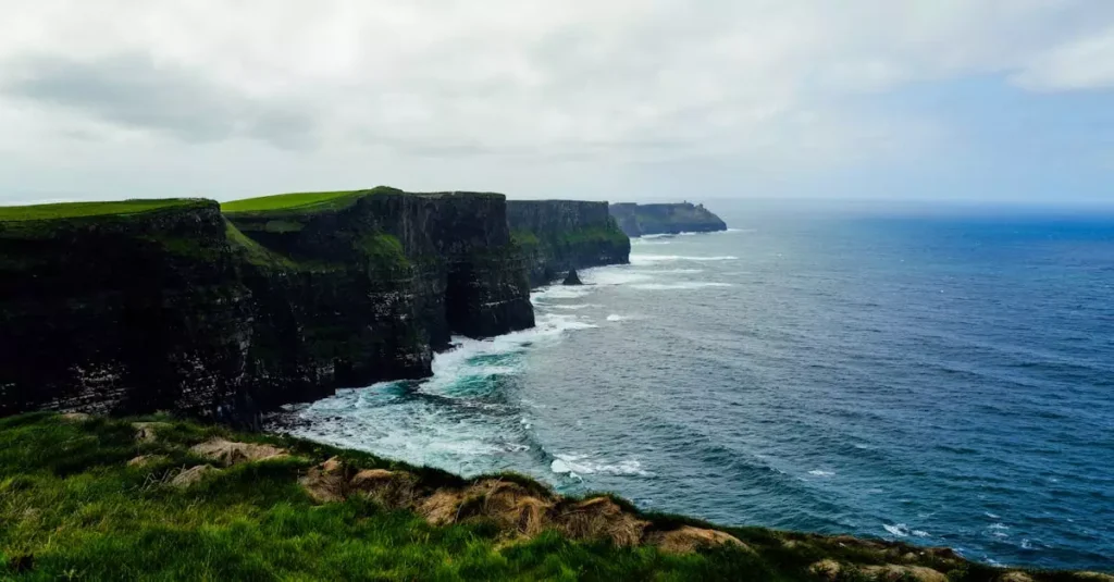 Best Beaches Ireland: Top Coastal Gems Revealed 2 Breathtaking view of the Cliffs of Moher with lush greenery and the vast Atlantic Ocean.