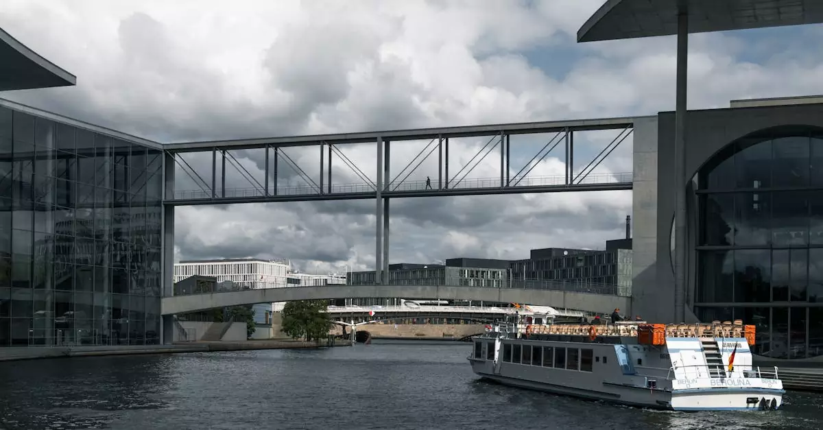 A ferry passing futuristic architecture along the Spree River in Berlin, Germany