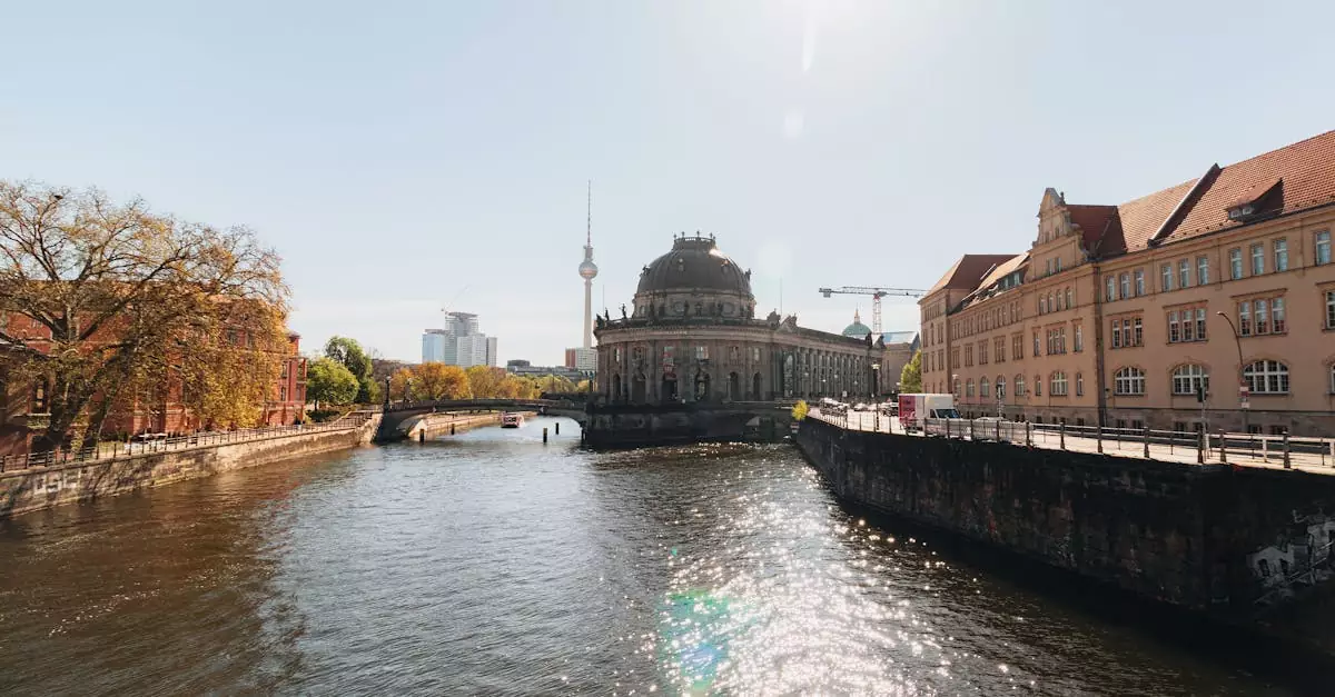 Captivating sunny view of Berlin's Bode Museum, Spree River, and iconic Fernsehturm with sparkling reflections.