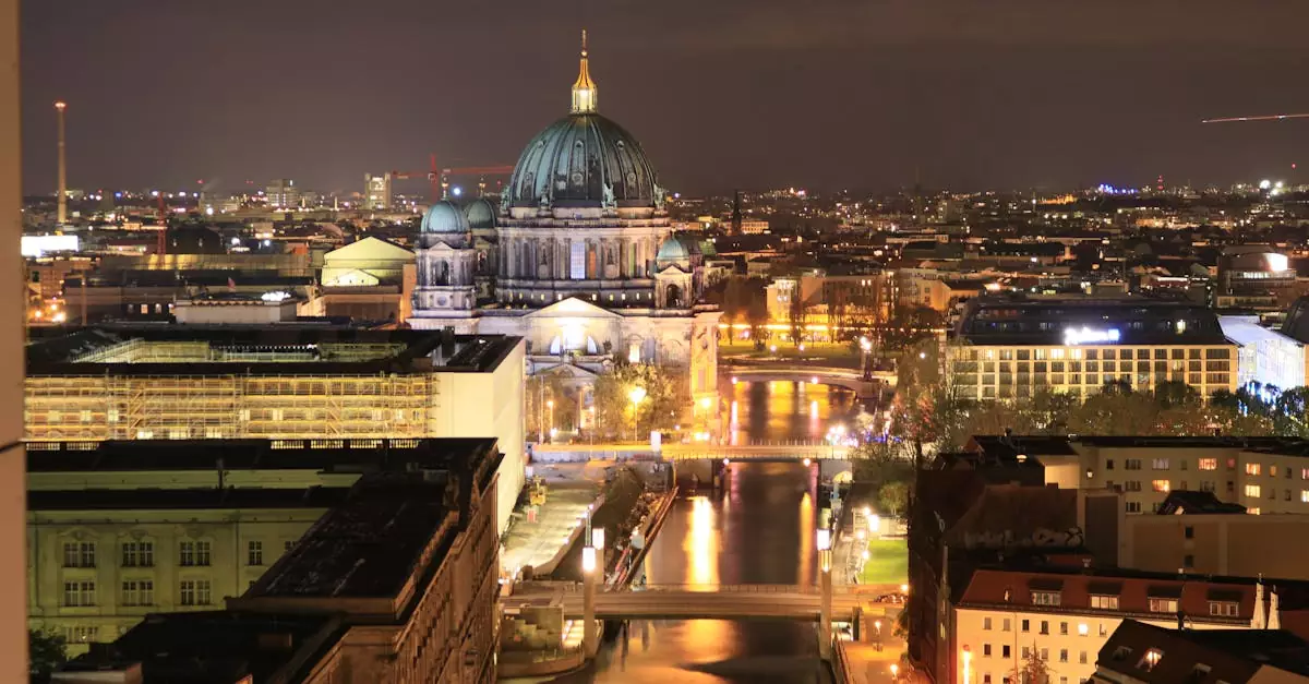 A breathtaking aerial shot of Berlin Cathedral illuminated at night, capturing the city's vibrant skyline and serene river.