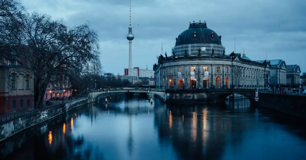 Best Berlin Museums: Your Guide to Art, History & Culture 2 Scenic view of Berlin's Museum Island with the Fernsehturm tower at dawn.