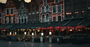 Explore the charming evening atmosphere of old town square cafes, featuring historic architecture and inviting lights.