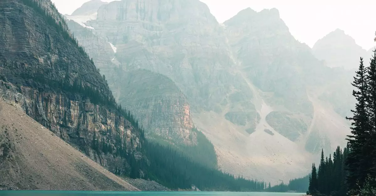Explore the tranquility of Moraine Lake in Banff's rugged wilderness with majestic mountains and serene waters.