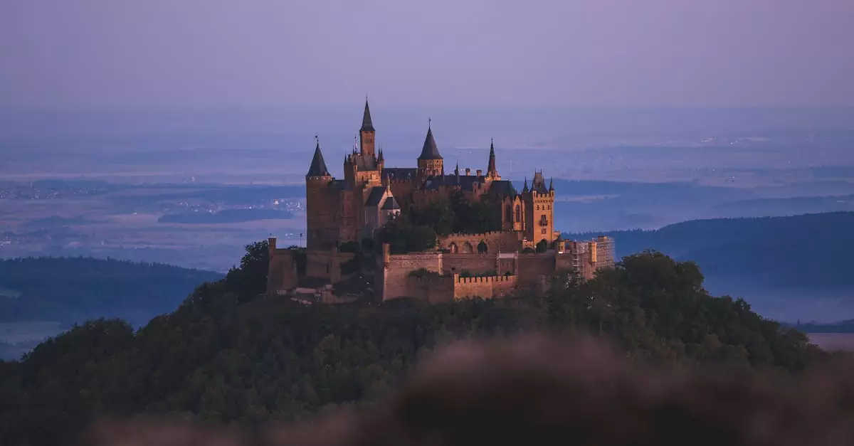 A breathtaking view of Hohenzollern Castle silhouetted against a pastel sunset sky.