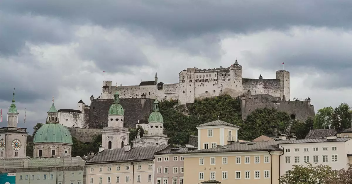 Dramatic skyline featuring Hohensalzburg Fortress over Salzburg's historic buildings on a cloudy day.