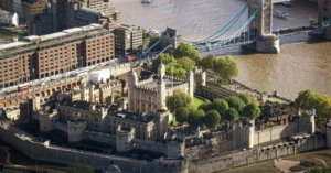 Aerial photograph of the iconic Tower of London and Tower Bridge across the River Thames.