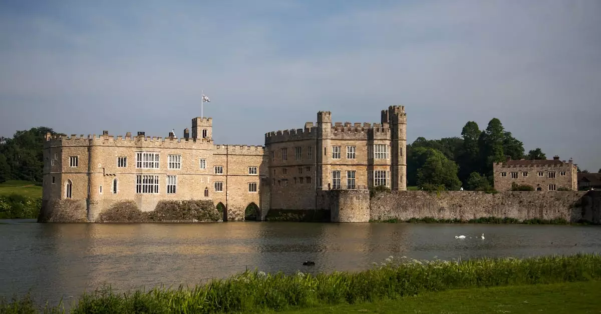 Beautiful view of the historic Leeds Castle surrounded by water under a clear sky.