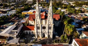 Stunning aerial view of a Gothic Cathedral in San Salvador, El Salvador, surrounded by cityscape.