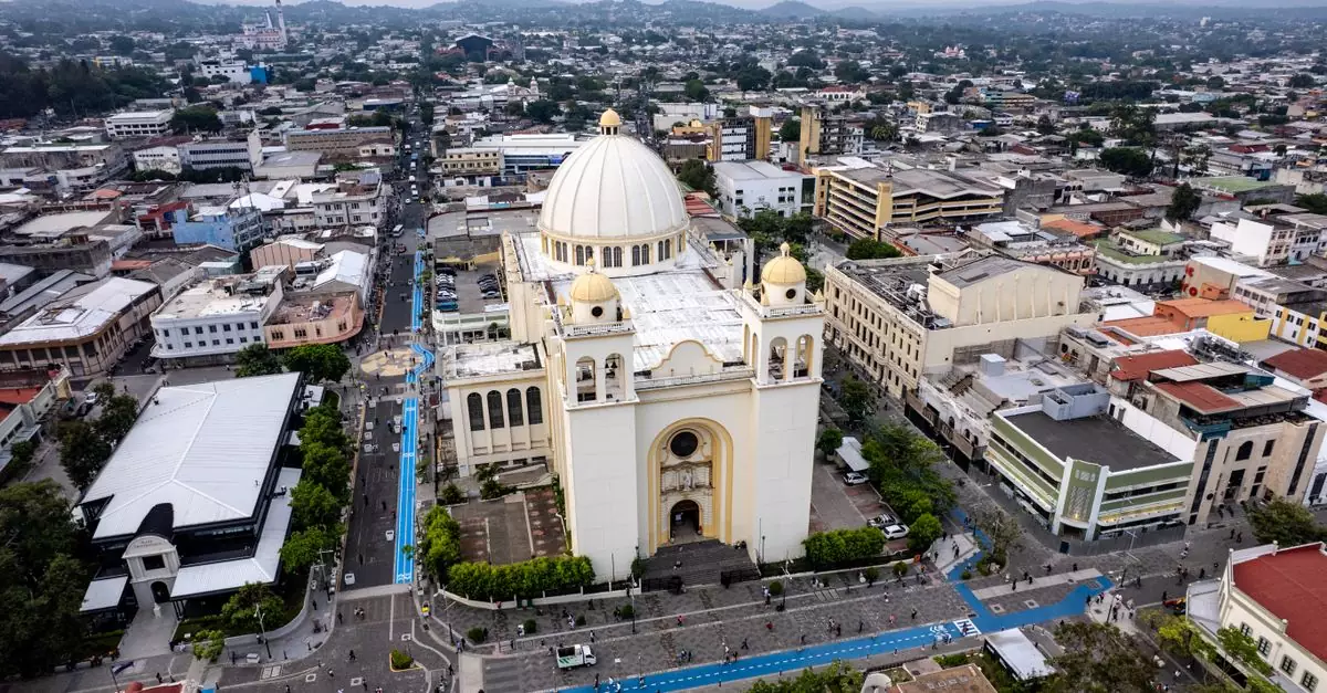 Aerial shot of the Metropolitan Cathedral in San Salvador's historic center, showcasing cityscape and urban architecture.