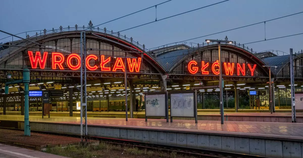 Neon signage at Wrocław Gł&oacute;wny station, a key transportation hub in Poland.