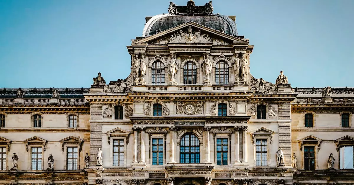 Classic baroque architecture of the iconic Louvre Museum in Paris, adorned with the French flag under a clear sky.