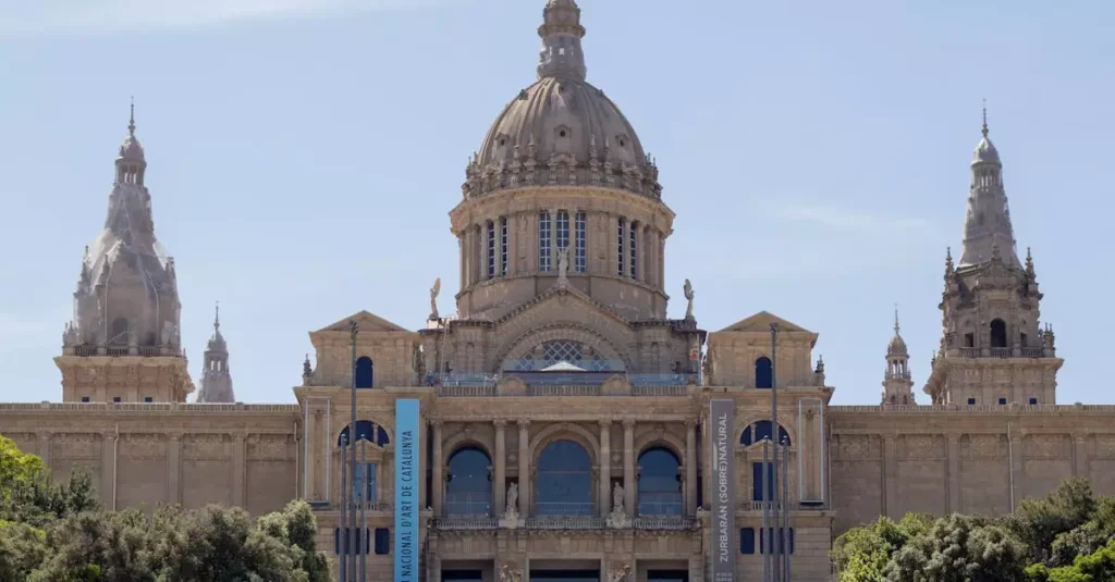 Front view of the National Art Museum of Catalonia showcasing its grand architecture under a clear sky.