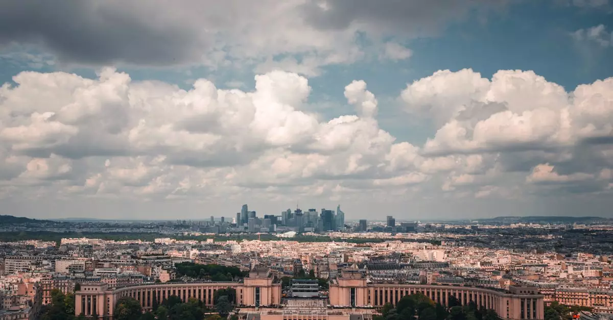 Breathtaking aerial view of Paris featuring iconic skyline under a dramatic cloudy sky.