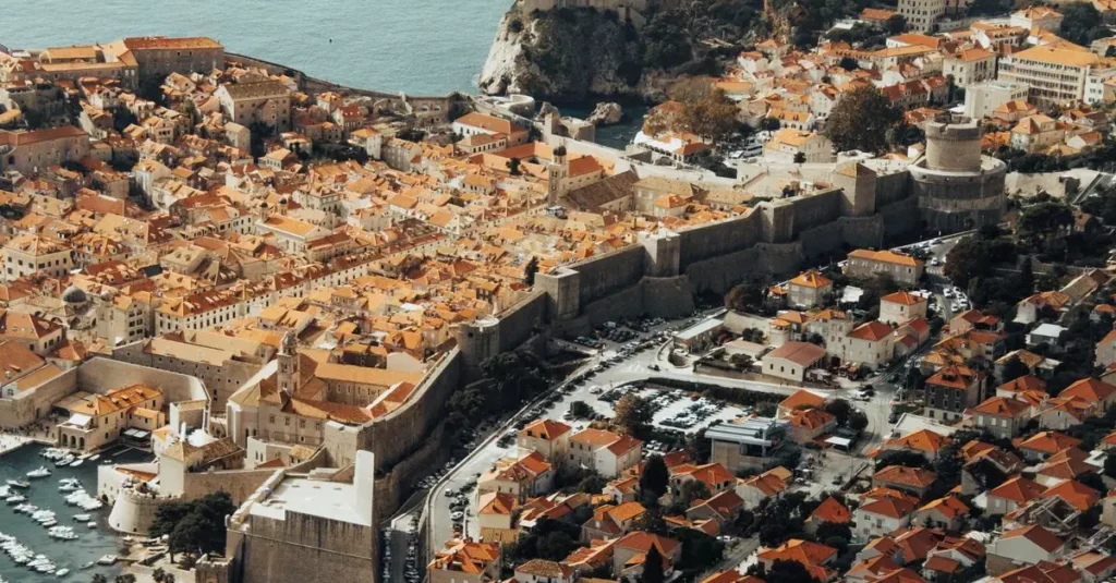Explore the stunning aerial view of Dubrovnik's fortified Old Town and its Mediterranean architecture.