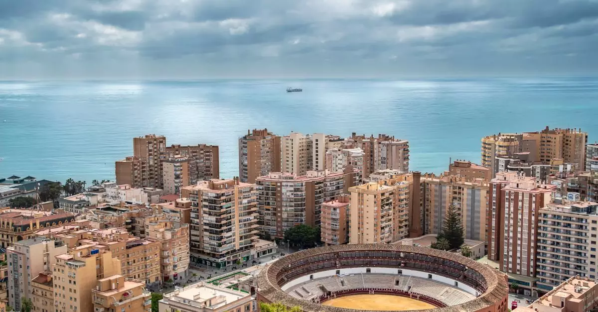 Aerial shot of Malaga's skyline featuring the bullring and sea horizon, perfect for travel themes.